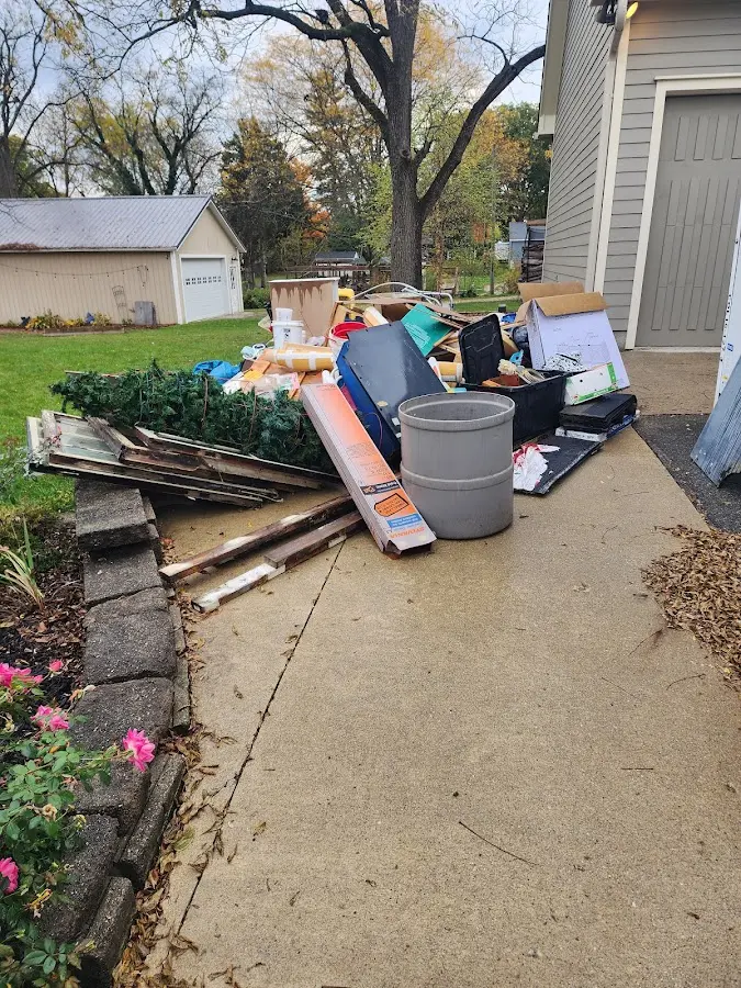 Dumpster being loaded with debris for Commercial Dumpster Rental in Urbandale